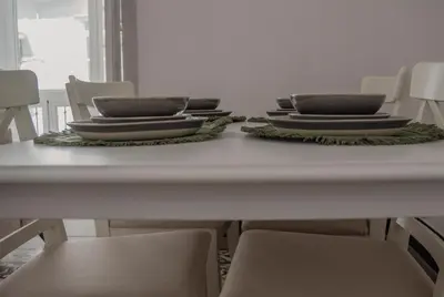 a white table with chairs and plates on it at Casa Herrete 15 in Medina Sidonia