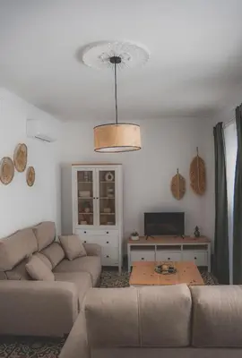 a living room with a couch and a table at Casa Herrete 15 in Medina Sidonia