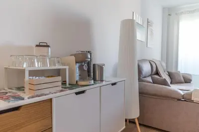 a living room with a counter with glasses on it at Las Salinas by Gades Gestión in Puerto Real