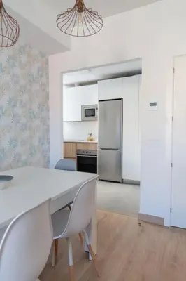 a kitchen with a white table and chairs in a room at Las Salinas by Gades Gestión in Puerto Real