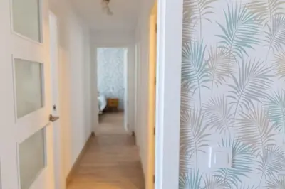 a hallway with blue and white wall paper and a hallway with a hallway at Las Salinas by Gades Gestión in Puerto Real