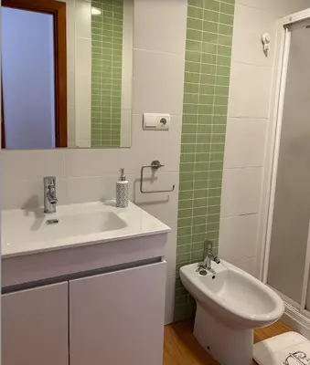 a bathroom with a sink and a toilet and a mirror at APARTAMENTO APARTACLUB REFORMADO in Chiclana de la Frontera