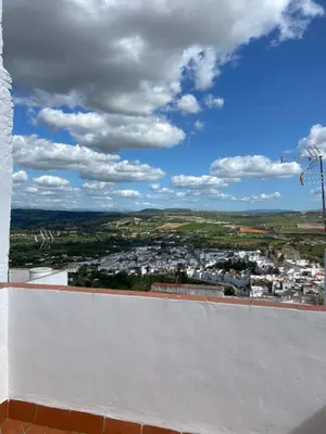 an old building with a clock tower in the distance at Casa El Rincón de San Pedro in Arcos de la Frontera