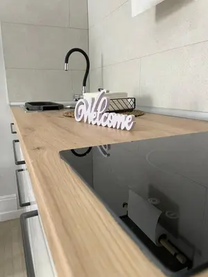a kitchen with a counter top with a sign on it at Apartamento corredera 1 in Arcos de la Frontera