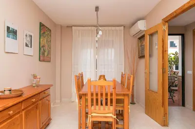 a kitchen and dining room with a table and chairs at Rosamar in Chiclana de la Frontera