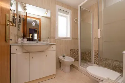 a bathroom with a sink and a toilet and a shower at Rosamar in Chiclana de la Frontera