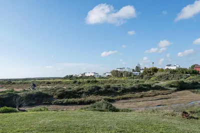 a person riding a bike on a grassy field at Rosamar in Chiclana de la Frontera