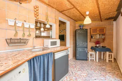 a kitchen with a sink and a microwave at Casa Amelie in Conil de la Frontera