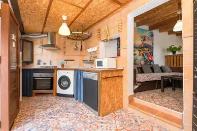 a kitchen with a washer and dryer in a room at Casa Amelie in Conil de la Frontera