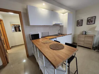 a kitchen with a wooden counter top in a room at Allo Apartments Caballeros II Centro 1 Habitación in Jerez de la Frontera