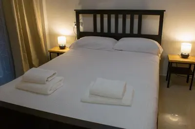 a large white bed with two towels on it at Allo Apartments Caballeros II Centro 1 Habitación in Jerez de la Frontera