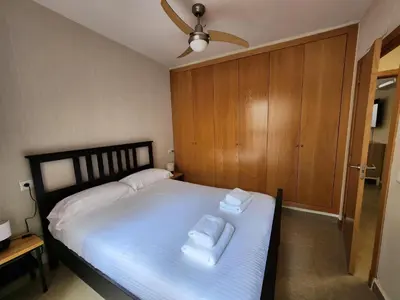 a bedroom with a bed with two towels on it at Allo Apartments Caballeros II Centro 1 Habitación in Jerez de la Frontera