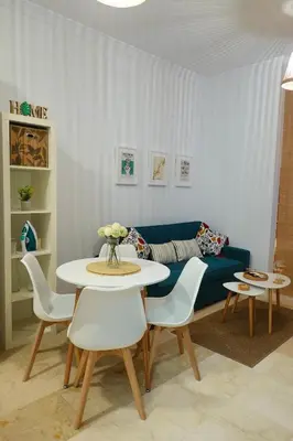 a living room with a couch and a table and chairs at Apartamento Langreo in Jerez de la Frontera