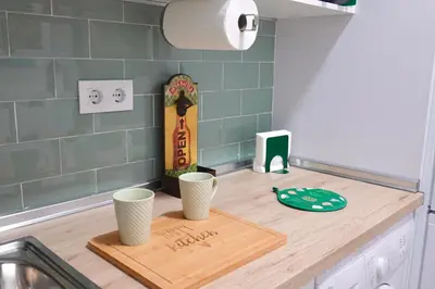 a kitchen counter with two cups on a cutting board at Apartamento Langreo in Jerez de la Frontera