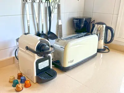 a kitchen counter with a toaster and other kitchen utensils at Villa Buganvilla Conil - SOLO FAMILIAS in Conil de la Frontera