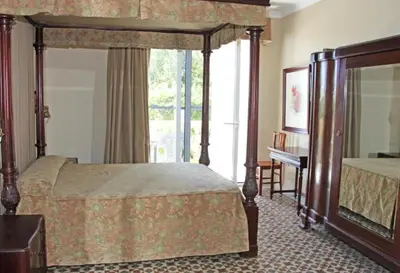 a bedroom with a canopy bed and a window at Hotel Al Sur De Chipiona by YouRoom in Chipiona