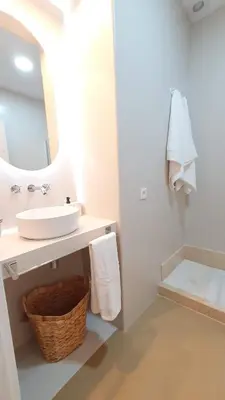 a white bathroom with a sink and a mirror at Casa Porvenir in Jerez de la Frontera