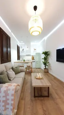 a living room with a couch and a table at Casa Porvenir in Jerez de la Frontera