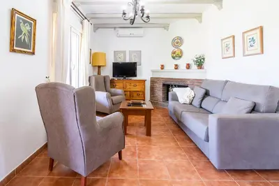 a living room with a couch and two chairs at Villas Dehesa Roche Viejo in Conil de la Frontera