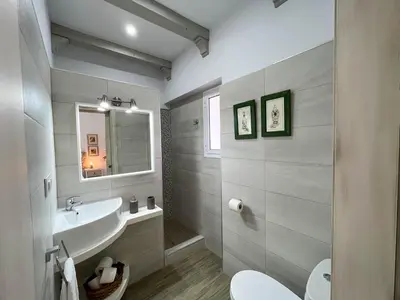 a white bathroom with a sink and a toilet at Villas Dehesa Roche Viejo in Conil de la Frontera