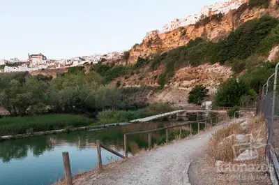 a dirt road next to a river next to a mountain at Casa con vistas en Arcos in Arcos de la Frontera