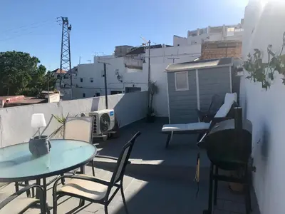 a balcony with a table and chairs on a roof at Casa con vistas en Arcos in Arcos de la Frontera