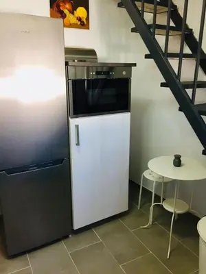 a refrigerator and a table in a room with a staircase at Casa con vistas en Arcos in Arcos de la Frontera