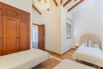 a bedroom with two beds and a mirror at Encantador piso Plaza Rivero in Jerez de la Frontera