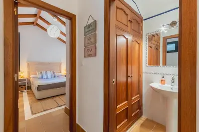 a bathroom with a sink and a bed in a room at Encantador piso Plaza Rivero in Jerez de la Frontera