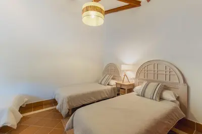 a bedroom with two beds and a light fixture at Encantador piso Plaza Rivero in Jerez de la Frontera