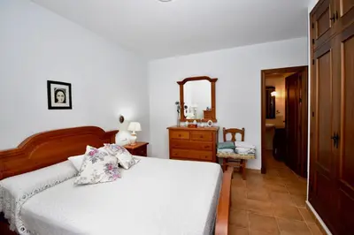 a bedroom with a bed and a dresser and a mirror at Recreo de Pilant - Holiday Chiclana in Chiclana de la Frontera