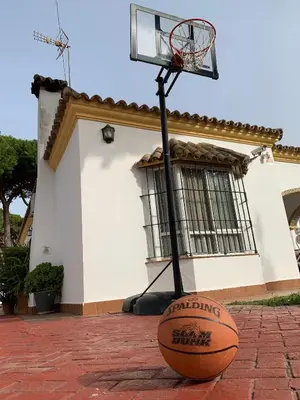a basketball hoop with a ball on the ground at Recreo de Pilant - Holiday Chiclana in Chiclana de la Frontera