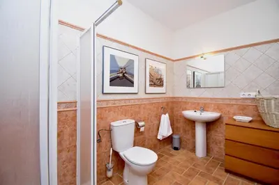 a bathroom with a toilet and a sink and a shower at Leonita in Chiclana de la Frontera