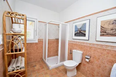a bathroom with a toilet and a shower at Leonita in Chiclana de la Frontera