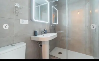 a bathroom with a sink and a glass shower at ATICO CALLE FARIÑAS in Sanlúcar de Barrameda