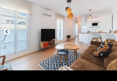 a living room with a couch and a table at ATICO CALLE FARIÑAS in Sanlúcar de Barrameda
