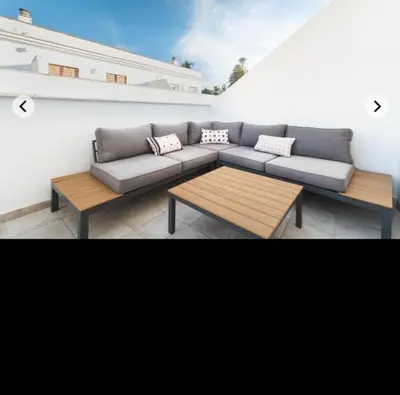 a living room with a couch and a coffee table at ATICO CALLE FARIÑAS in Sanlúcar de Barrameda