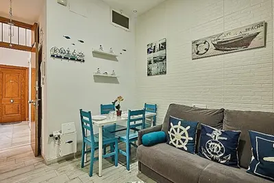 a living room with a couch and a table with chairs at The Sailors House Ha in Cádiz