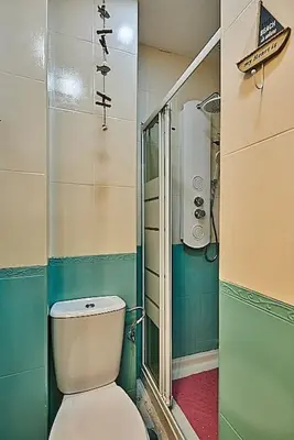 a small bathroom with a toilet and a shower at The Sailors House Ha in Cádiz