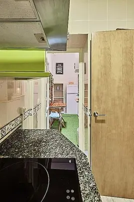 a kitchen with a counter and a door to a room at The Sailors House Ha in Cádiz