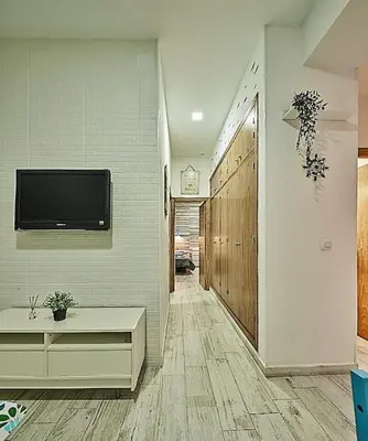 a hallway with a flat screen tv on a wall at The Sailors House Ha in Cádiz