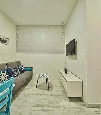 a living room with a couch and a tv at The Sailors House Ha in Cádiz