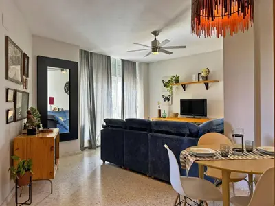 a living room with a blue couch and a table at Apartamento Santiago - Ole Solutions in Jerez de la Frontera