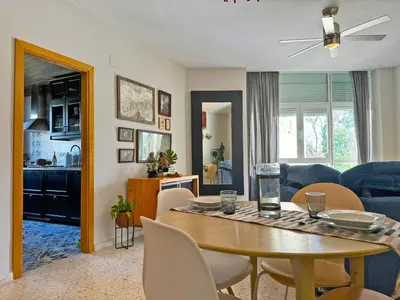a kitchen and living room with a table and chairs at Apartamento Santiago - Ole Solutions in Jerez de la Frontera
