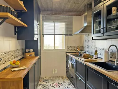 a kitchen with a sink and a stove top oven at Apartamento Santiago - Ole Solutions in Jerez de la Frontera