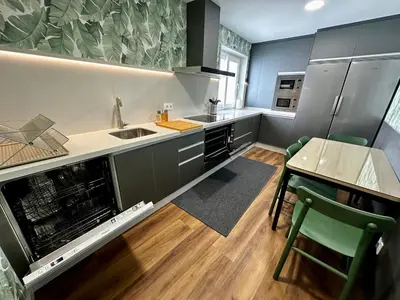 a kitchen with a sink and a table with chairs at BASTINAZO ALOHADREAM - LUXURY PREMIUM - DormirDCategoria Condetó en la Mejor Ubicación de la Ciudad, Especial Grupos, Insonorizado, Aire Acondicionado en todas las habitaciones, TV 100