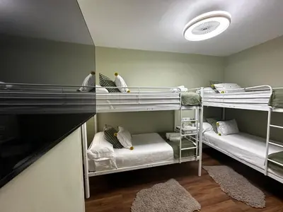 a room with two bunk beds and a mirror at BASTINAZO ALOHADREAM - LUXURY PREMIUM - DormirDCategoria Condetó en la Mejor Ubicación de la Ciudad, Especial Grupos, Insonorizado, Aire Acondicionado en todas las habitaciones, TV 100