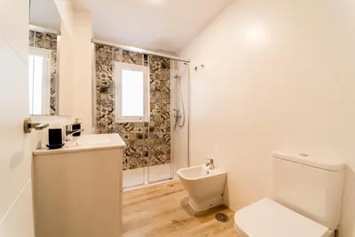 a white bathroom with a toilet and a shower at Fabio Catedral II in Cádiz