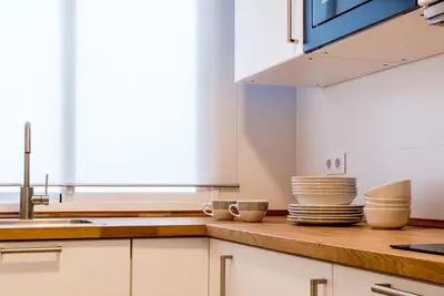 a kitchen with white cabinets and a sink at Fabio Catedral II in Cádiz