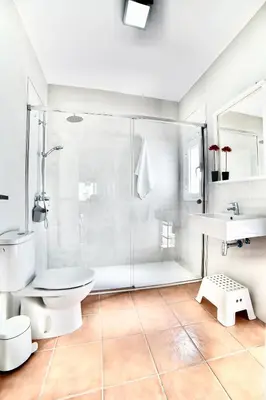 a bathroom with a shower and a toilet and a sink at VILLA YUCA CON PISCINA PRIVADA en CONIL DE LA FRONTERA in Conil de la Frontera